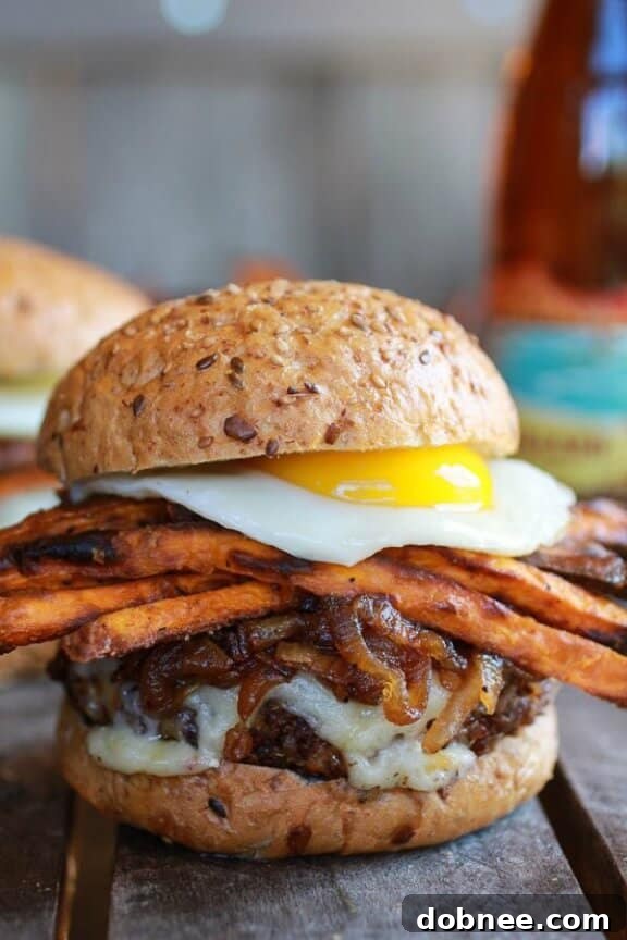 Epic Crispy Quinoa Burgers Topped with Sweet Potato Fries, Beer Caramelized Onions & Gruyere from Half Baked Harvest