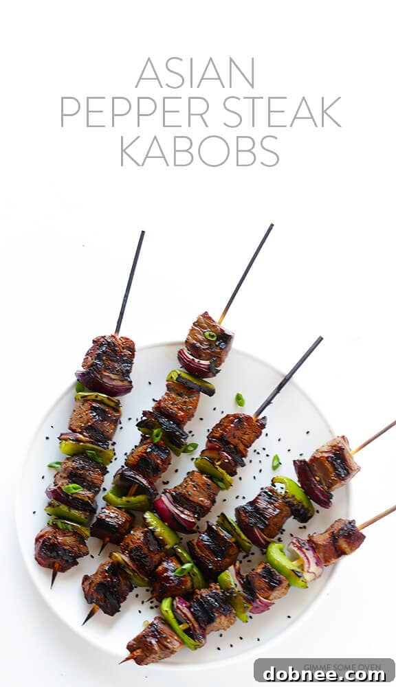 Asian Pepper Steak Kabobs served with fresh greens and a side of rice for a complete meal.
