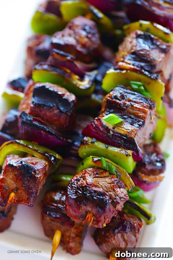 Colorful skewers with marinated steak, bell peppers, and onions, ready for the grill.