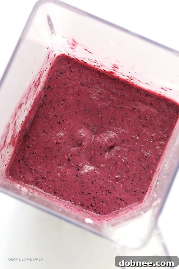 Smoothie ingredients blending together for a vibrant drink.