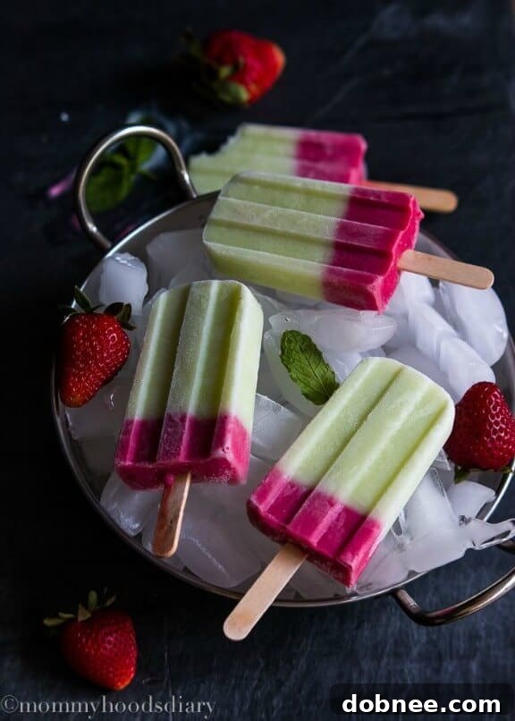 15 Stunning Summer Popsicle Treats 13 Healthy Honeydew and Berries Yogurt Popsicles by Mommyhood's Diary, packed with fruit and yogurt.