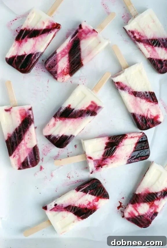 15 Stunning Summer Popsicle Treats 8 Visually appealing Striped Berry Buttermilk Popsicles from Brooklyn Supper.