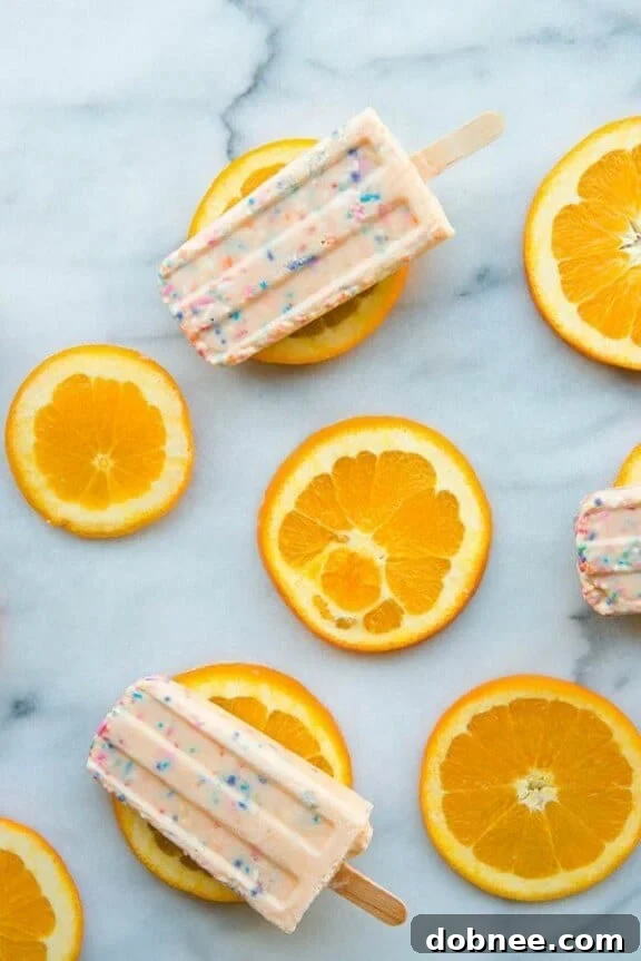 15 Stunning Summer Popsicle Treats 4 Joyful Funfetti Creamsicles by Studio DIY, bringing back childhood memories with sprinkles.