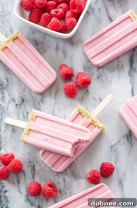 15 Stunning Summer Popsicle Treats 5 Delicious Raspberry Cheesecake Yogurt Popsicles from Recipe Runner, a healthy and creamy treat.