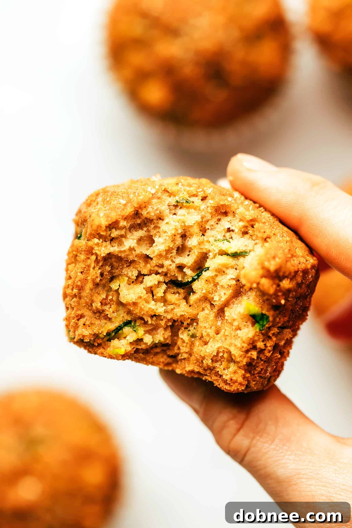 A close-up of the muffin batter with grated zucchini and oats mixed in, before baking.