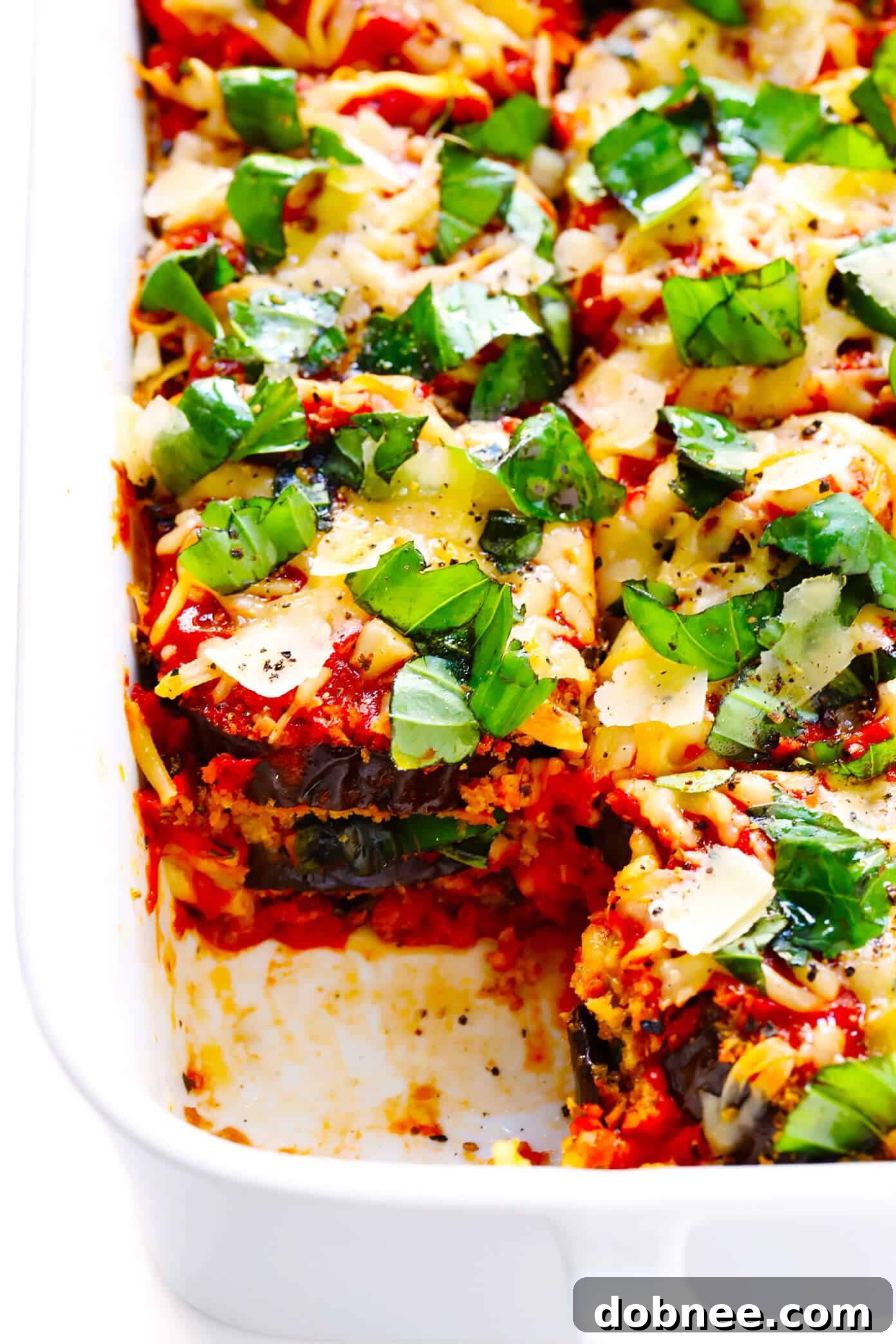 Delicious Baked Eggplant Parmesan layers with marinara sauce, mozzarella, and basil