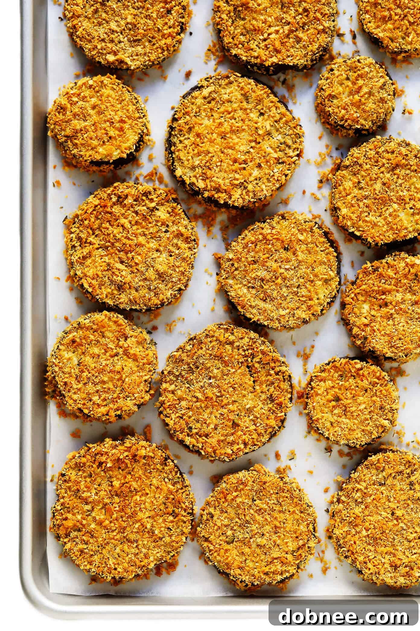Crispy oven-fried panko-crusted roasted eggplant slices, ready for layering in Baked Eggplant Parmesan
