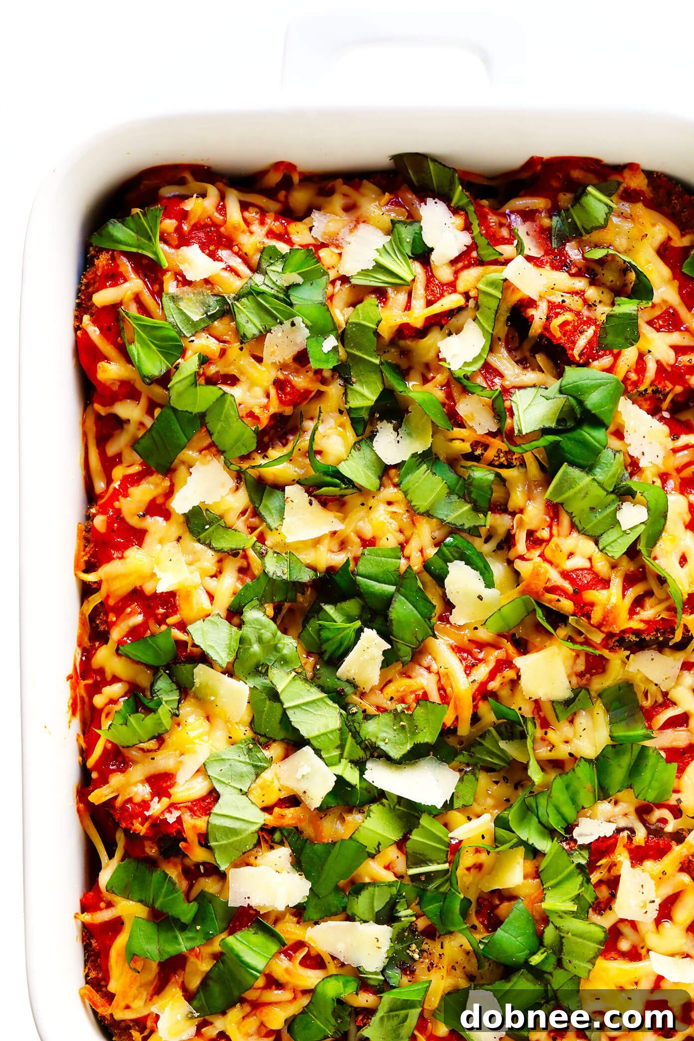Close-up of healthy Baked Eggplant Parmesan, garnished with fresh basil leaves