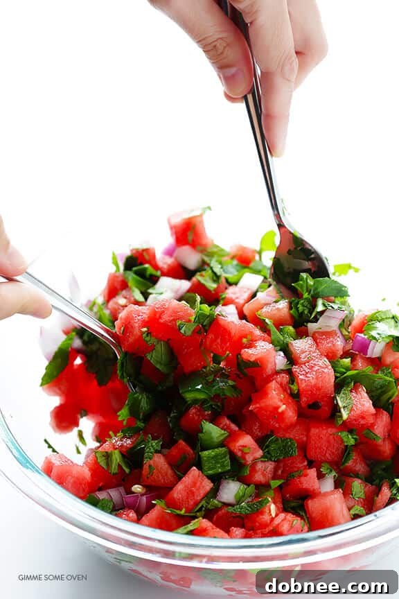 Mixing all the fresh ingredients for homemade watermelon salsa.