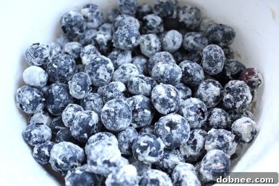 Slice of Blueberry Zucchini Bread Close-up of a slice of Blueberry Zucchini Bread, showing the moist texture and blueberries.