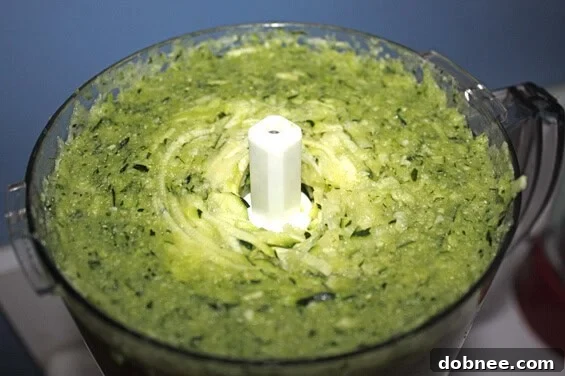 Blueberry Zucchini Bread on cutting board A whole loaf of Blueberry Zucchini Bread on a cutting board, ready to be sliced.