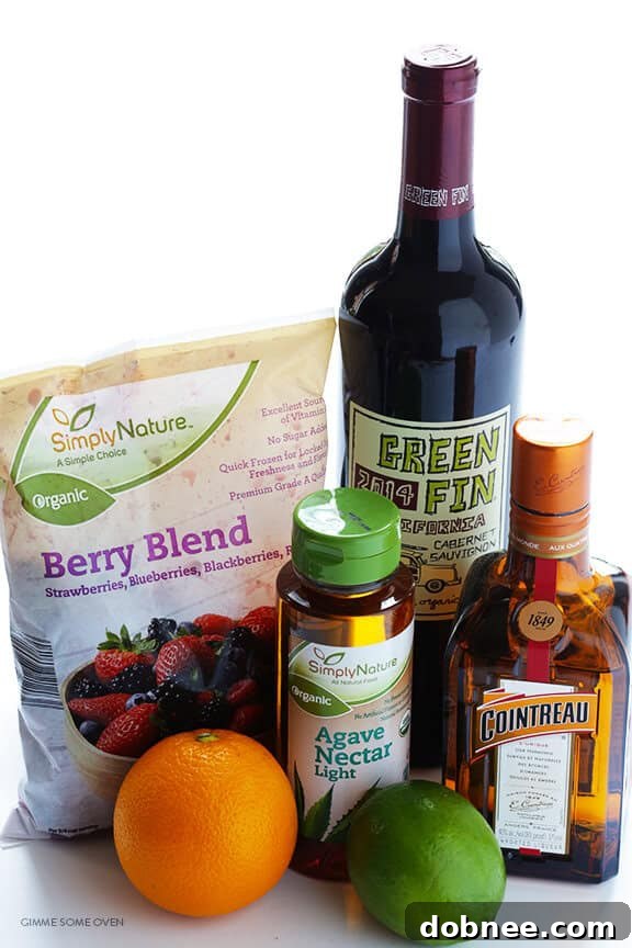 Close-up of a glass of Frozen Sangria with berries and an orange slice