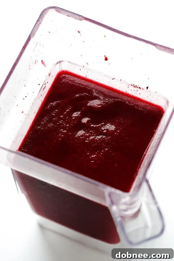 Pouring frozen sangria from a blender into a glass