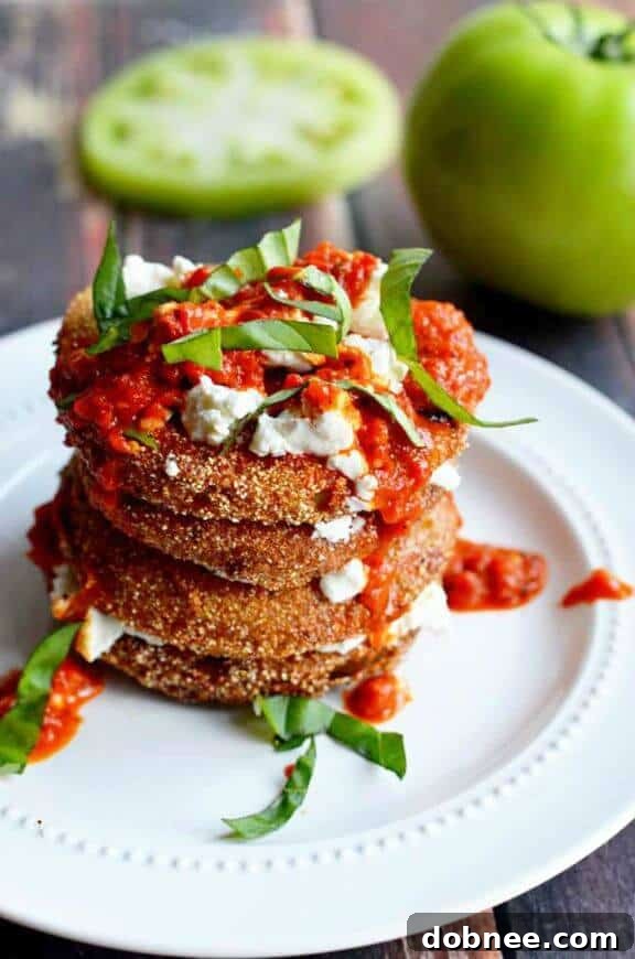 Fried Green Tomatoes with Goat Cheese and Roasted Red Pepper Vinaigrette - a Southern classic with a gourmet twist.