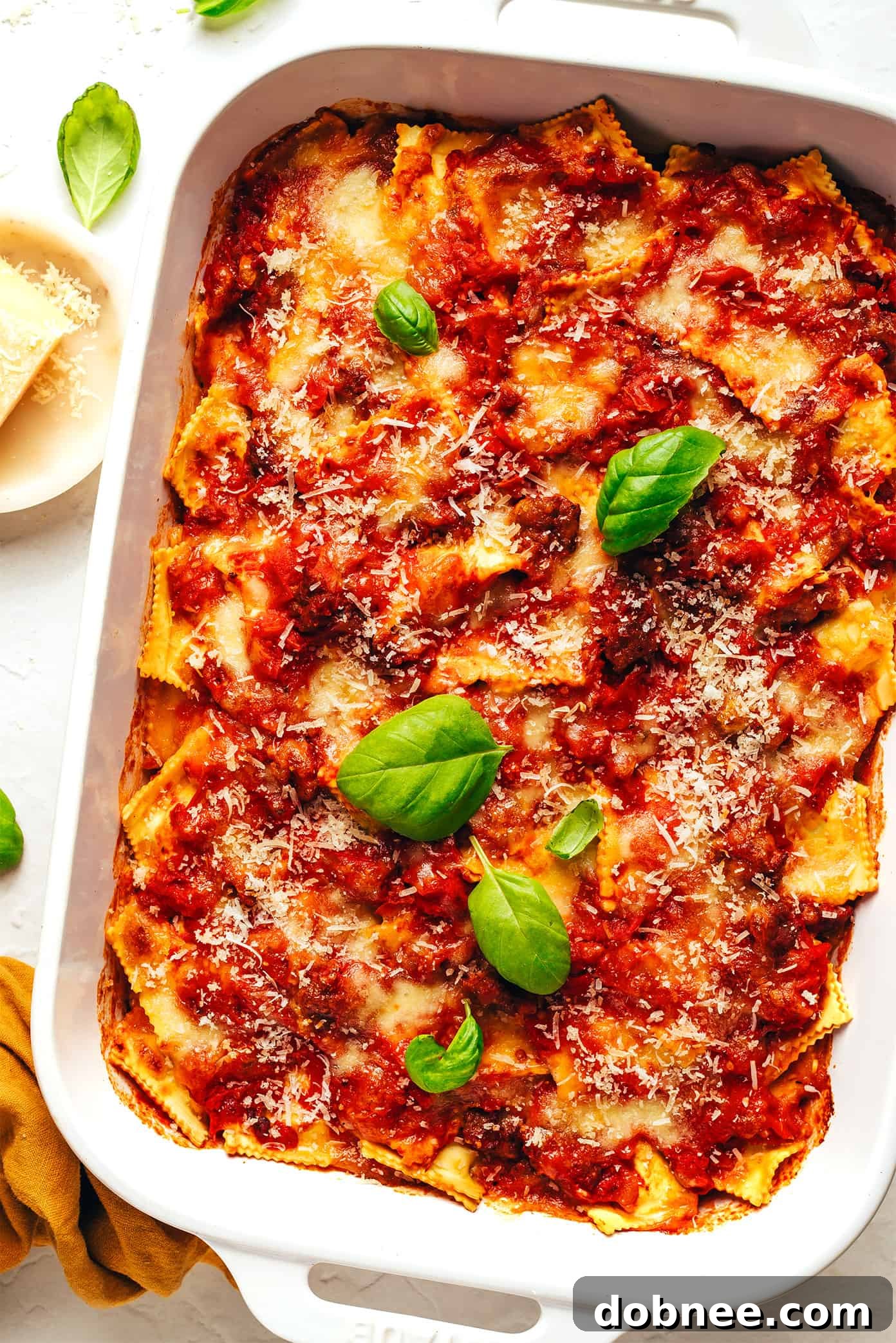 Delicious baked ravioli lasagna with melted cheese and fresh basil