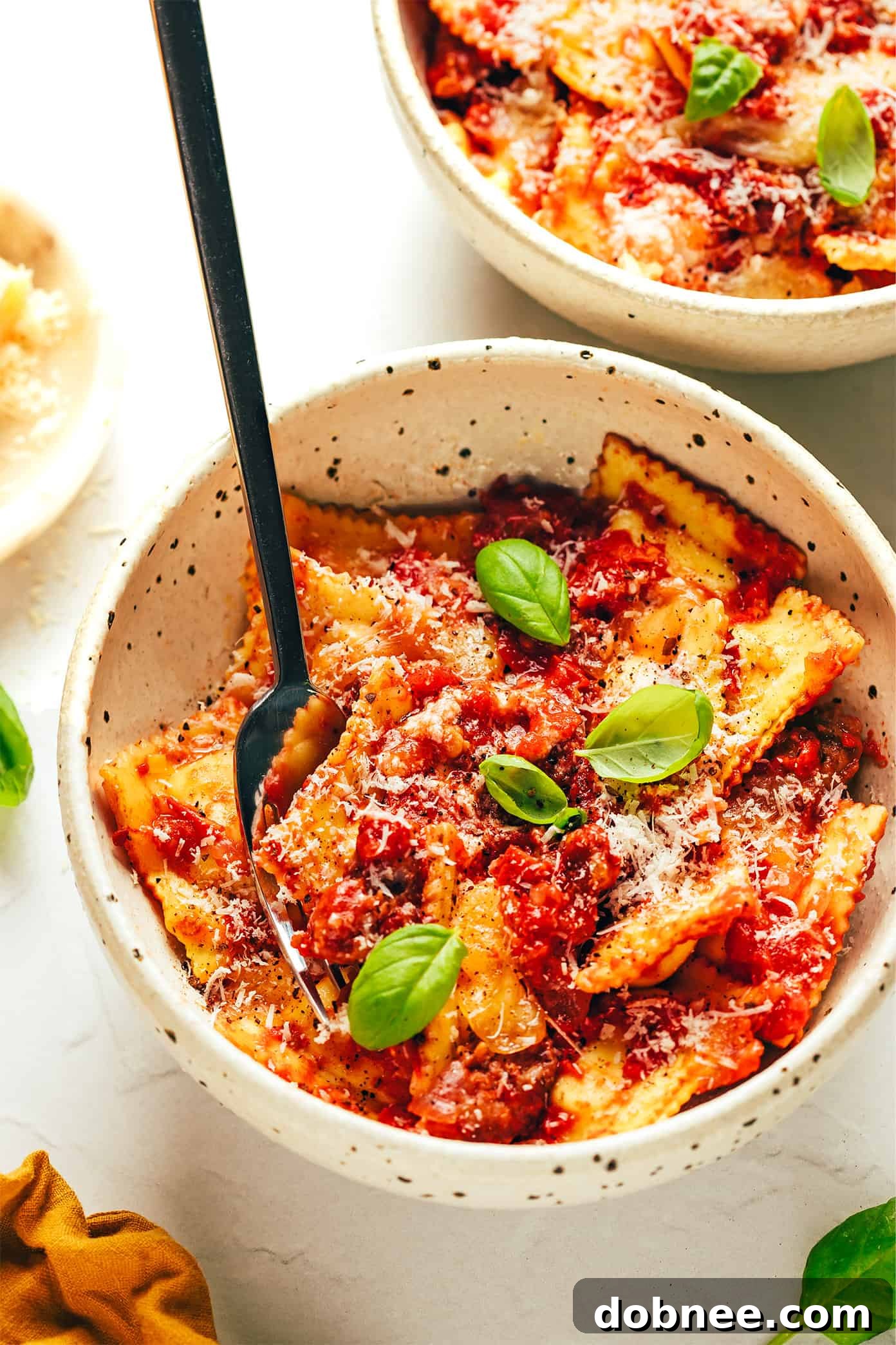 A serving of ravioli lasagna in a bowl, ready to eat