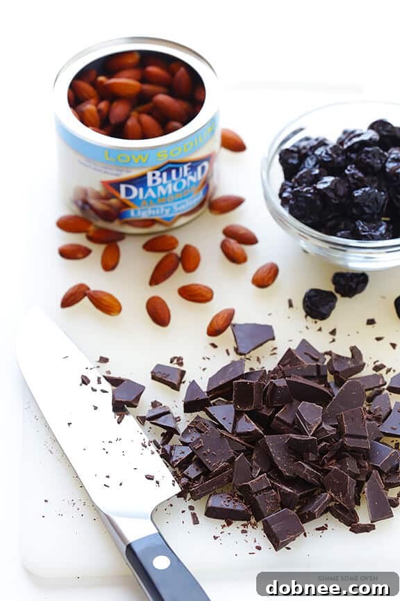 A close-up shot of the base granola mixture featuring oats, almonds, and shredded coconut.