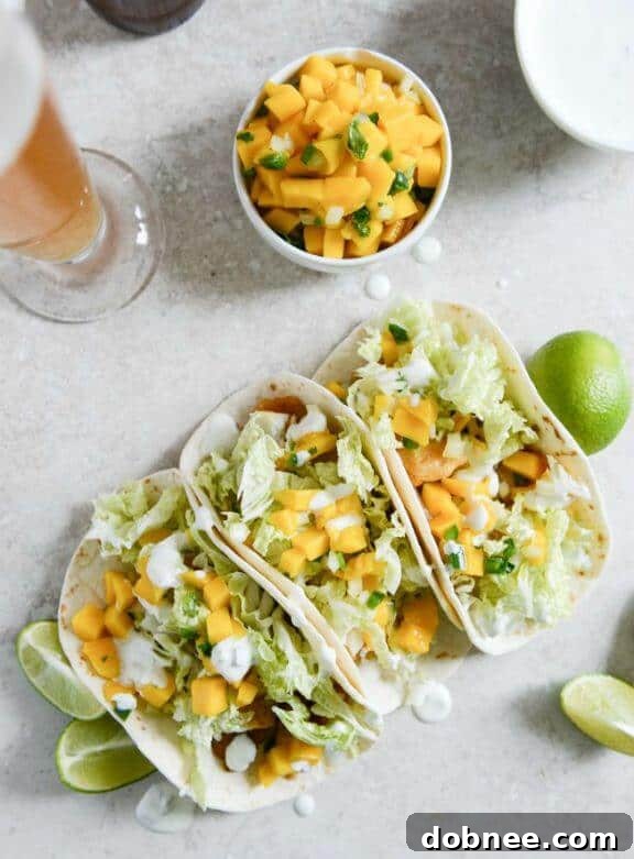 Beer Battered Fish Tacos with Margarita Mango Salsa and Jalapeño Crema | howsweeteats.com