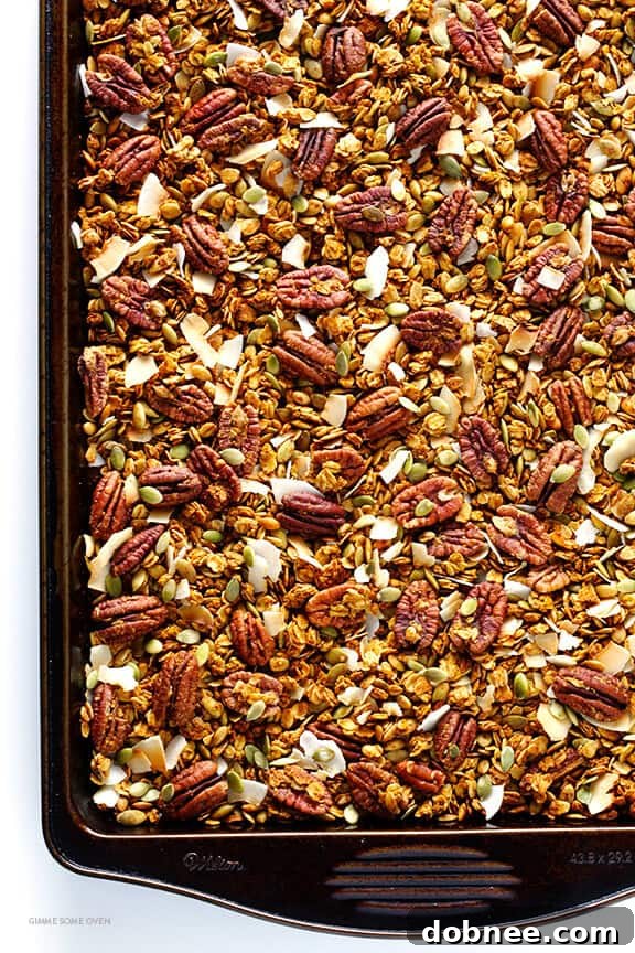 Golden brown Pumpkin Spice Granola cooling on a baking sheet