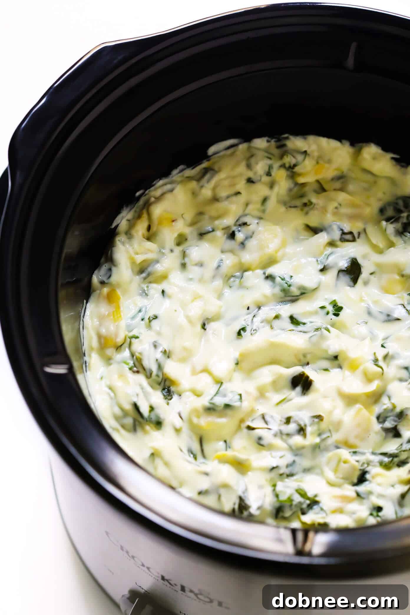 Slow Cooker Spinach Artichoke Dip Recipe - The ultimate creamy, cheesy, and easy appetizer for parties and game day.
