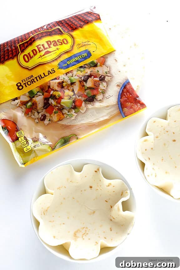 Adding shredded cheese and tortilla strips to the Chicken Enchilada Skillet for a melty, crunchy texture.