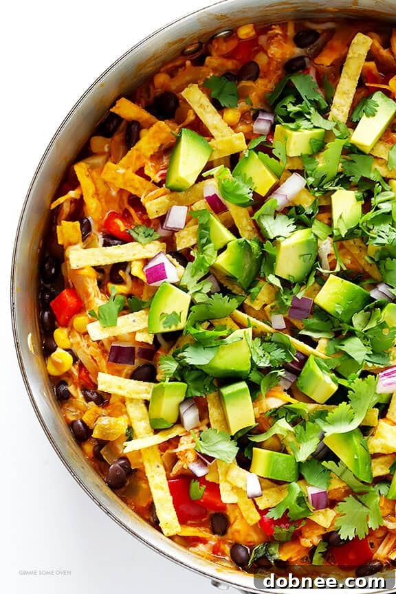 Filling Old El Paso flour tortilla bowls with the cheesy, savory Easy Chicken Enchilada Skillet mixture.