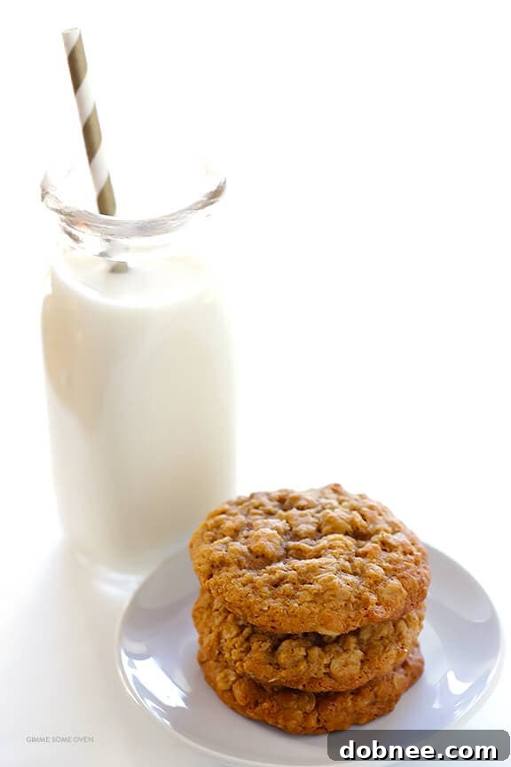 A plate full of golden-brown whole wheat oatmeal cookies, highlighting their soft texture and wholesome ingredients.