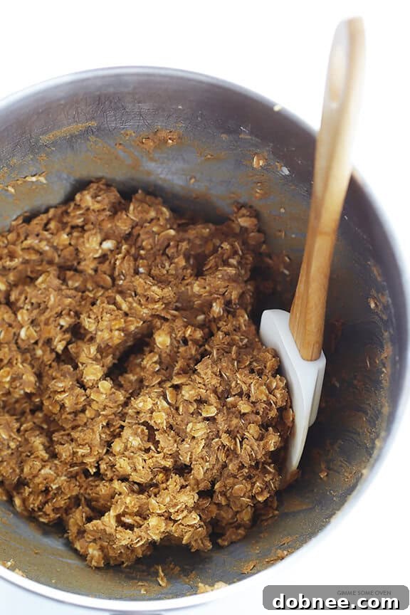 Close-up of a stack of whole wheat oatmeal cookies, showing their hearty texture and inviting golden edges.