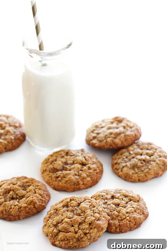 Freshly baked whole wheat oatmeal cookies cooling on a wire rack, ready to be enjoyed.