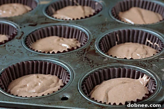 A close-up of a frosted Mayan Chocolate Cupcake, showcasing the rich cocoa and cinnamon buttercream with a focus on its inviting texture.