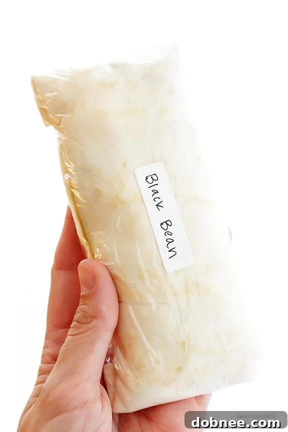 A plate of freshly prepared freezer breakfast burritos, ready to be wrapped and stored. Ideal for quick, on-the-go breakfasts.