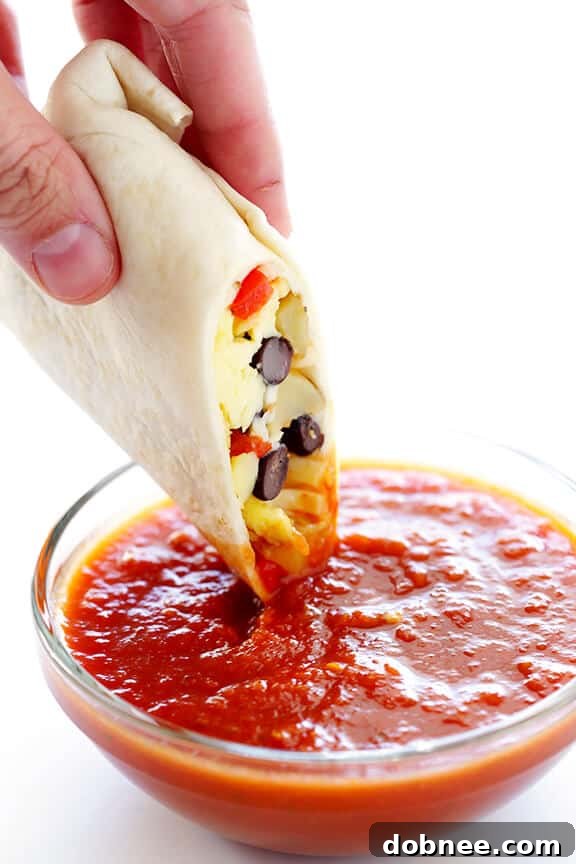 An array of delicious freezer breakfast burritos, perfectly wrapped and ready for the freezer, showcasing the efficiency of meal prepping.