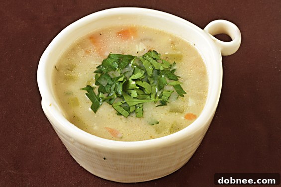 A warm bowl of Roasted Garlic & Brie Soup, perfect for cold weather.