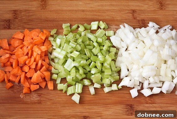 Serving bowl of creamy Roasted Garlic & Brie Soup, garnished with fresh herbs.