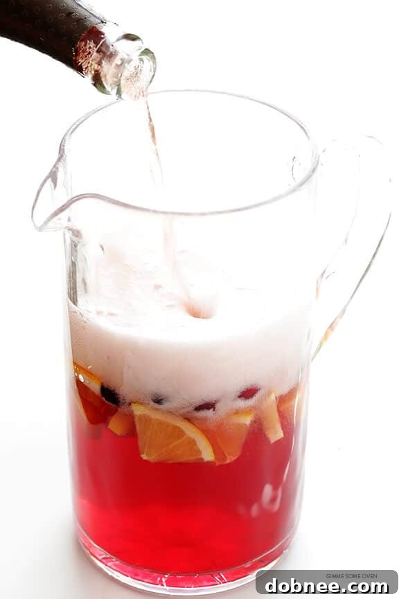 Sparkling Cranberry Orange Sangria Recipe -- quick and easy to make, and perfect for the holidays or any good party! | gimmesomeoven.com