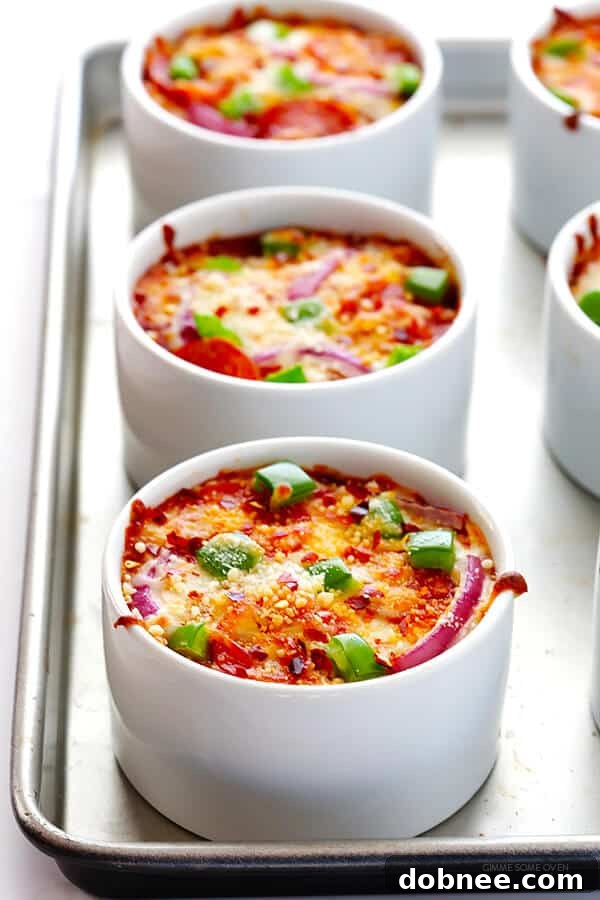 Quinoa Pizza Bowls fresh from the oven, with bubbly, golden-brown cheese and vibrant toppings.