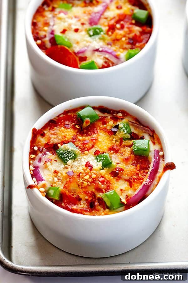 Close-up of a finished Easy Quinoa Pizza Bowl, topped with fresh Parmesan and crushed red pepper flakes.
