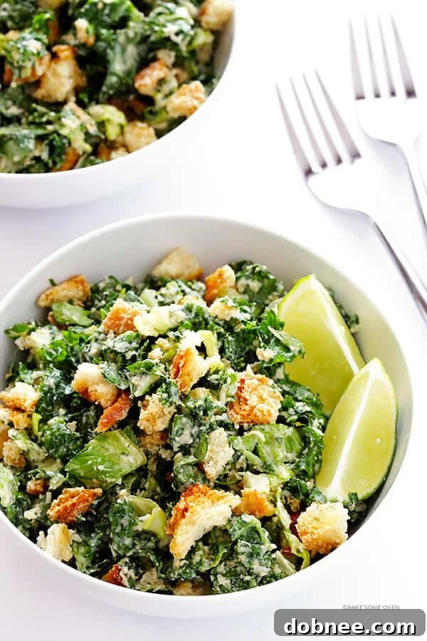 Vibrant Kale Caesar Salad with light lime dressing, served in a rustic bowl.