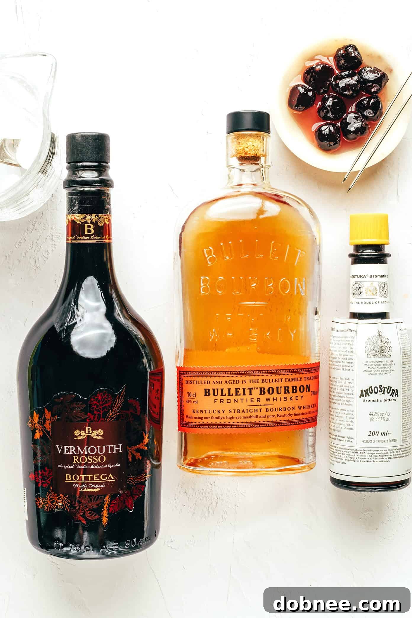 A perfectly stirred Manhattan cocktail in a chilled glass, garnished with a rich Luxardo cherry