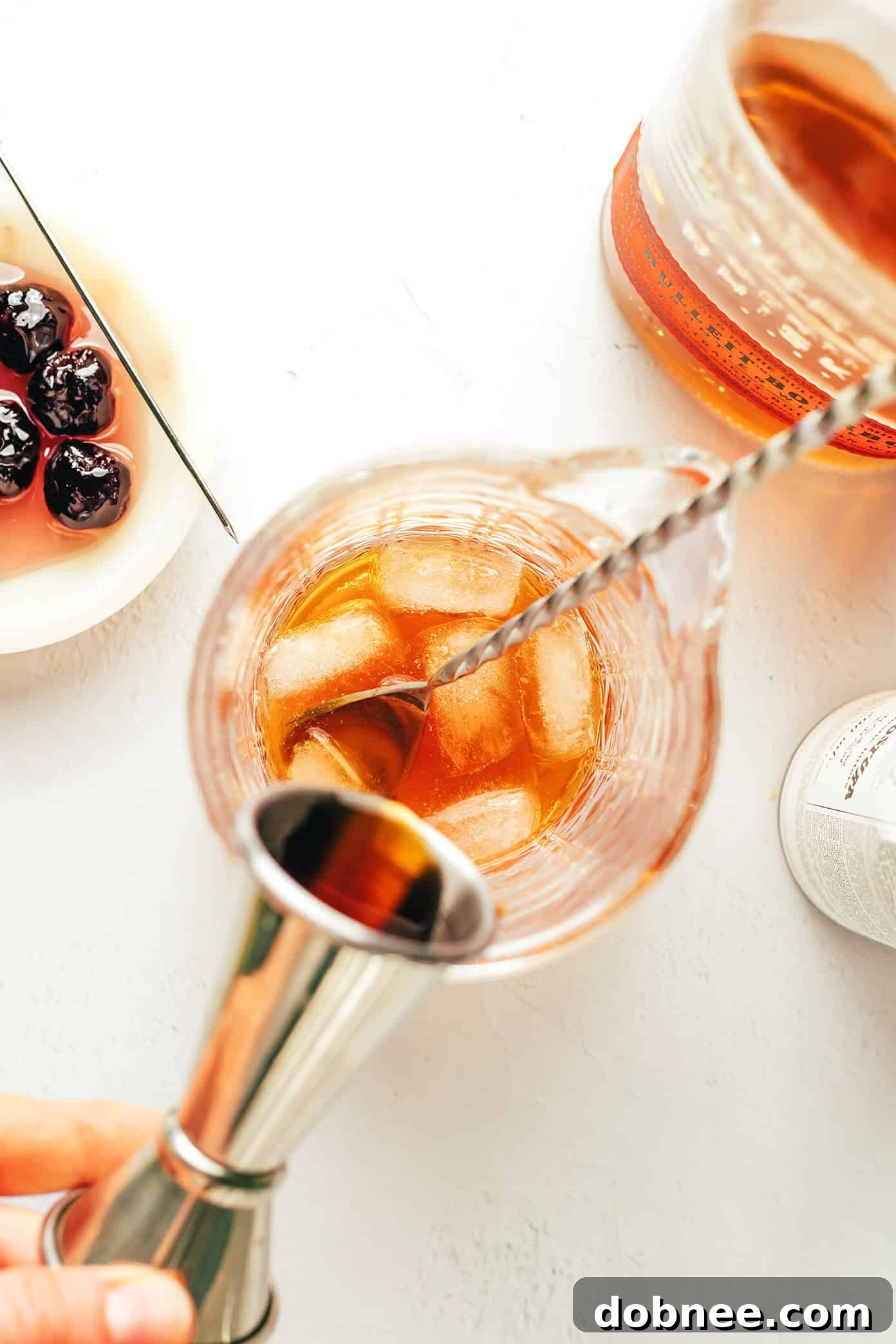 Close-up shot of the Manhattan cocktail ingredients: bourbon, vermouth, and bitters, ready for mixing