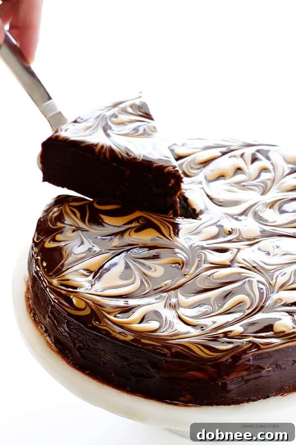 Another perspective of the Peanut Butter Flourless Chocolate Cake, highlighting its height and the intricate swirl pattern on top.