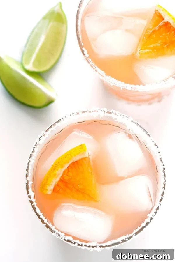 Refreshing Grapefruit Margarita with a salted rim and fresh slices, perfect for a happy hour