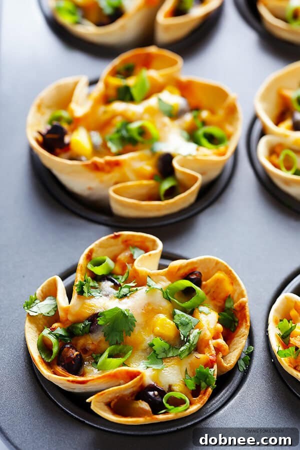 Freshly baked Easy Enchilada Cups garnished with green onions and cilantro, presented for serving