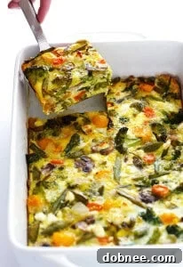 A beautifully baked Spring Vegetable Egg Casserole with fresh herbs, ready to serve.