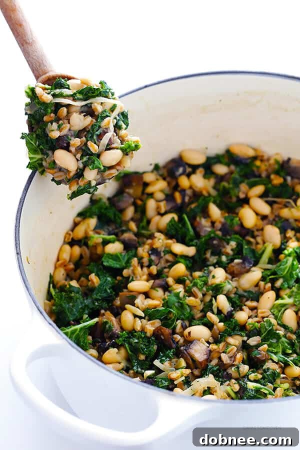 A serving of Creamy Farro with White Beans and Kale, garnished and ready to be enjoyed.