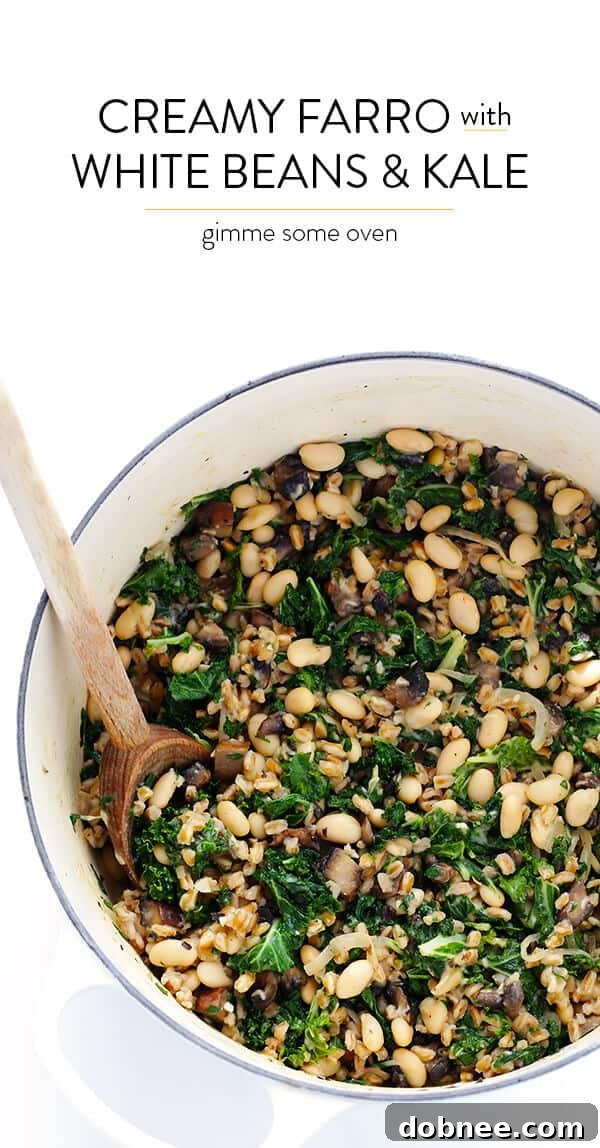 A beautifully styled shot of Creamy Farro with White Beans and Kale in a rustic bowl, ready to eat.