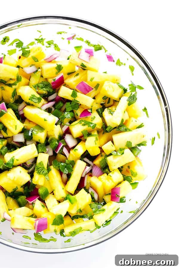 Close-up of a Pineapple Black Bean Tostada, showcasing its vibrant layers of salsa, avocado, and beans on a crispy shell.