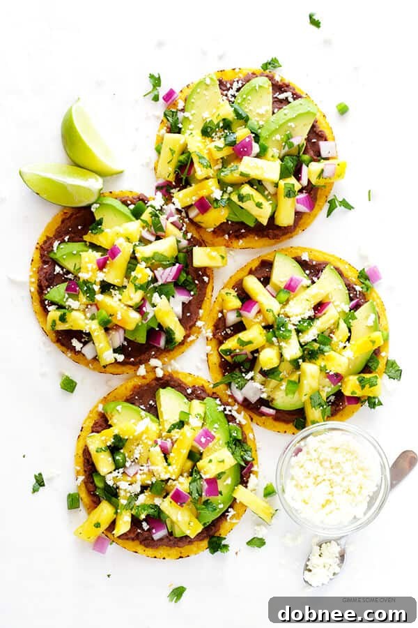 A close-up shot of multiple Pineapple Black Bean Tostadas arranged beautifully on a serving platter.