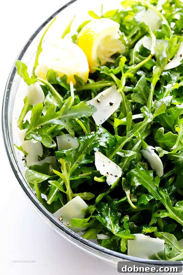 A large bowl of the freshly tossed 5-Ingredient Arugula Salad, ready to be served and enjoyed.