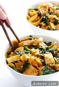 Homemade Pad See Ew with wide rice noodles, chicken, and Chinese broccoli.